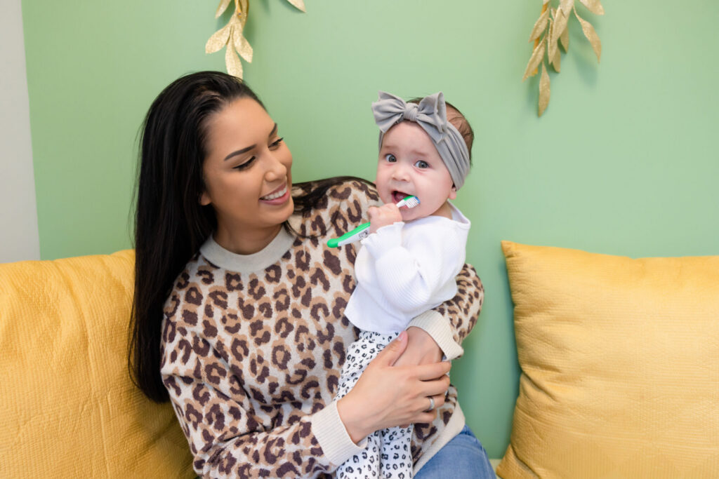 A baby playing with a tooth brush