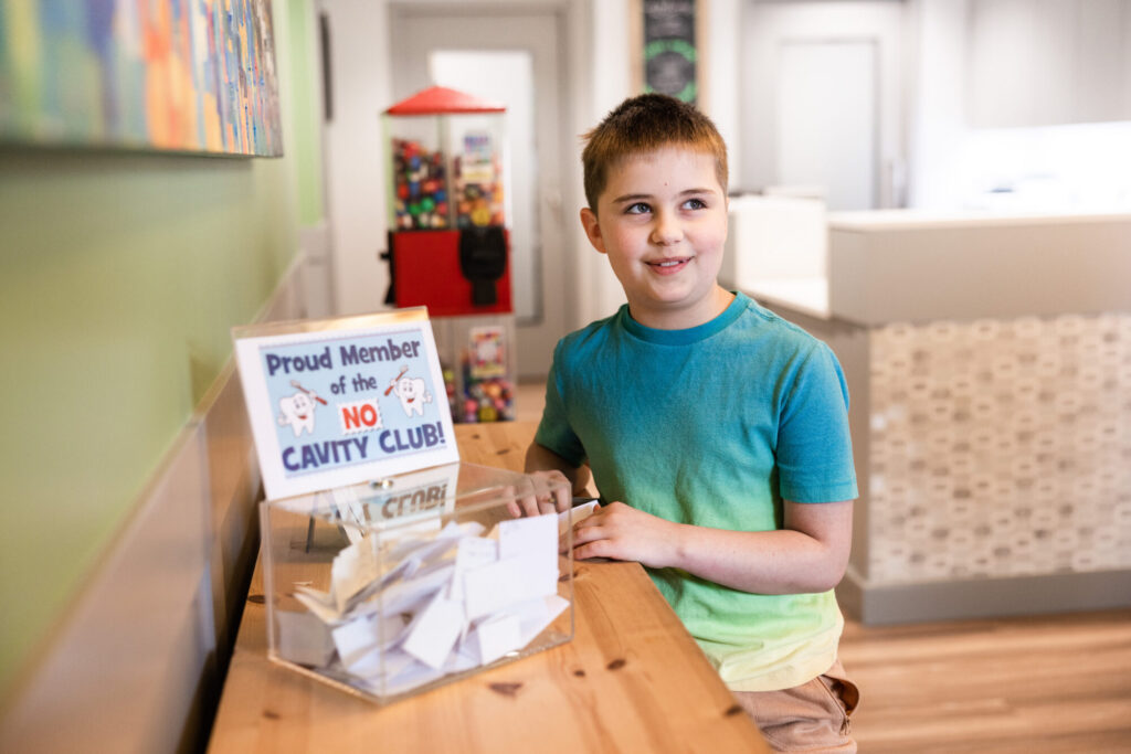 Young man signing name for the No Cavity Club